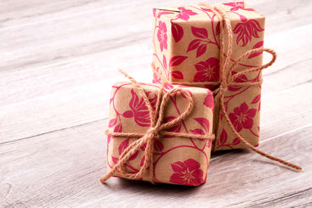 Boxes wrapped in gift paper. Presents and bows from rope. Lovely packages for gifts. Great ideas for presents decoration.の写真素材