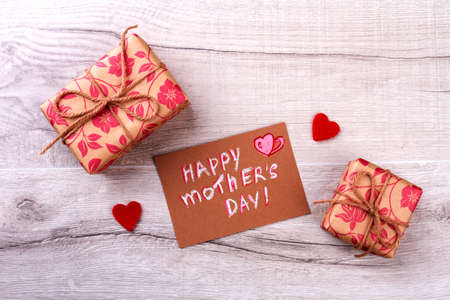 Greeting card on Mother`s Day. Fabric hearts and wrapped gifts. Share love with mom. Bring the mood of holiday.の写真素材