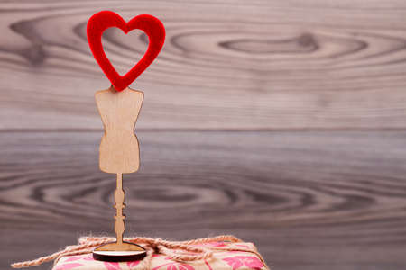 Red heart on wooden stand. Rope bow and heart. Positive mood on Valentine`s Day. Wishes of joy and love.の写真素材