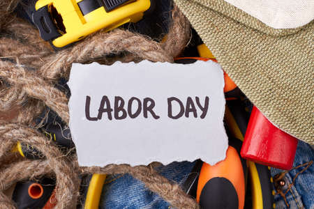 Paper near bunch of tools. Repairing items and greeting card. Official public holiday.の写真素材