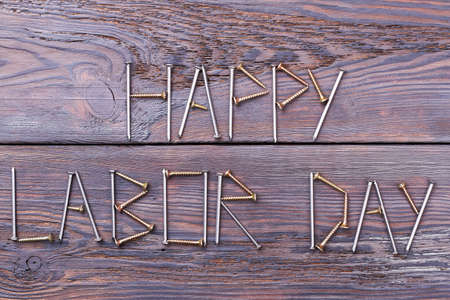 Happy Labor Day inscription. Text made by screws. Congratulation in original manner.の写真素材