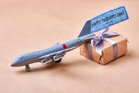 Father Day card and gift. Toy plane near present box. Cute gift in childish style.の写真素材