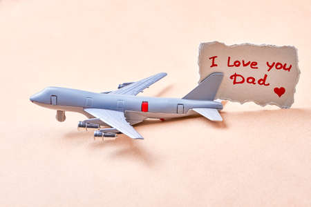 I love you dad card. Toy plane near greeting paper. Child in all of us.の写真素材