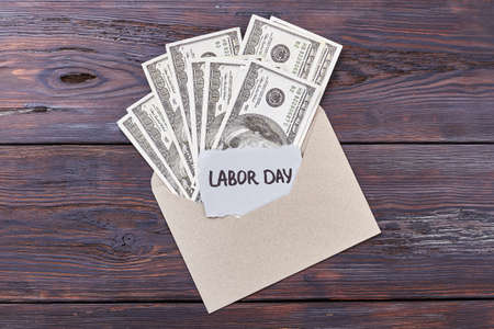 Dollars in envelope and card. Money near Labor Day card. Always a valuable gift.の写真素材