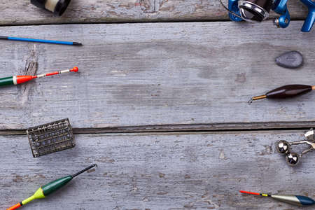 Fishing tackle on wooden background. Equipment for catching fish. Fishing as a hobby.の写真素材
