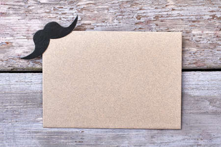 Blank paper with mustache. Empty paper on wooden background. Create your party invitation.の写真素材