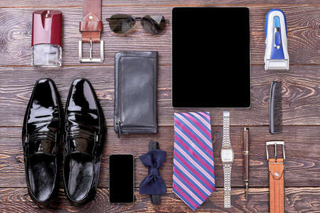 Watch, shoes and gadgets. Bow tie, wallet and cologne. Good look by few steps.の写真素材