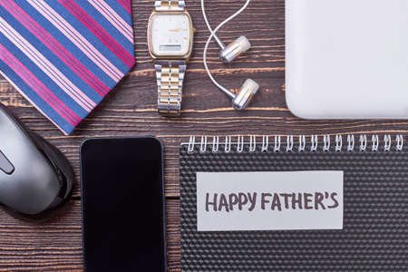 Computer mouse, smartphone and tablet. Earphones near greeting card. Accessories express your personality.の写真素材