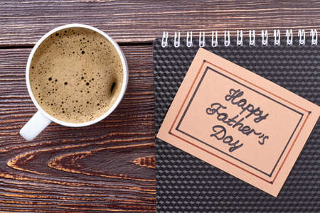 Father's Day card and coffee. Cup of coffee and notebook. Tasty drink that refreshes.の写真素材