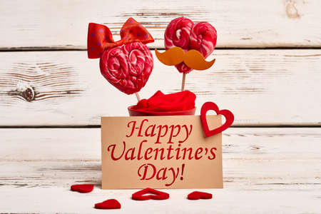 Lollipops and Valentines Day card. Hearts and red candies. Sweet taste of love.の写真素材