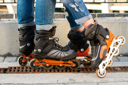 Legs wearing roller blade. Black and orange inline skates. Improved materials and new design.の写真素材