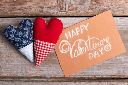 Valentines Day card and hearts. Fabric hearts on wooden background. The magic of love.の写真素材