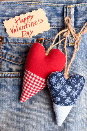 Fabric hearts on jeans pocket. Valentines Day card and denim. Lovely and cute present.の写真素材