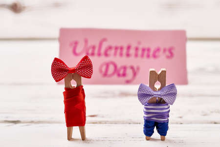 Clothespin couple on wooden background. Greeting card and clothespin couple. Prepare surprise on Valentines Day.の写真素材