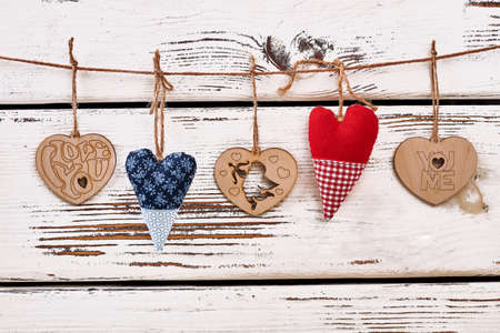 Hearts on string. Hearts on white wooden background. Results of handmade.