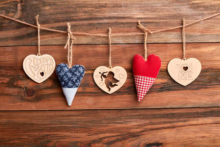 Hearts on rope. Hearts on brown wooden surface. Create positive and romantic mood.の写真素材