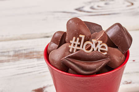 Hashtag symbol love inscription. Pot with lip-shaped candies. Make romantic gestures.