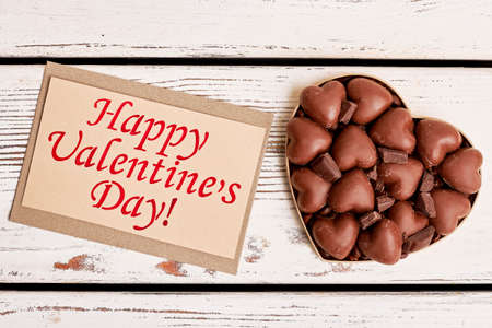 Chocolates on Valentines Day. Sweets near greeting card. Spend this day with beloved.の写真素材