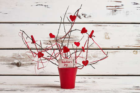 Tree branches and fabric hearts. Branches and bead garland. Decorate room for Valentines Day.の写真素材