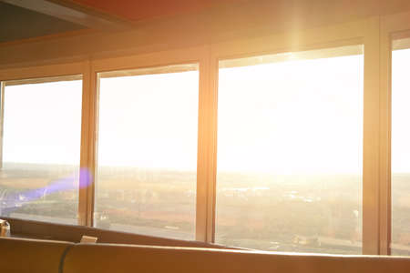 Windows and sunlight. Horizon and white sky. High above the ground.の写真素材