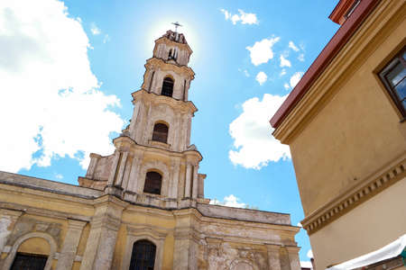Old tower with cross. Religious building on sky background. Be closer to God.の写真素材