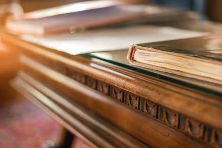 Book on old wooden table. Desk and sunlight. Study history and uncover secrets.