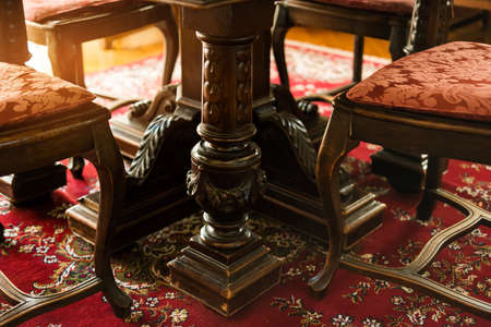 Antique wood furniture. Classic chairs on the carpet. The art of carving.の写真素材