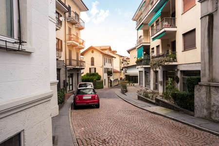 Road and town buildings. Cars parked in the street. Spend Summer in Italy.の写真素材
