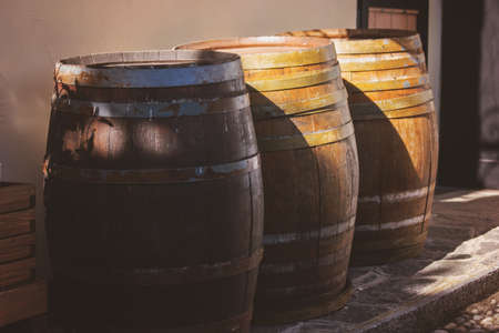 Old wooden barrels outdoor. Barrels under sunlight. Containers for wine storage.の写真素材