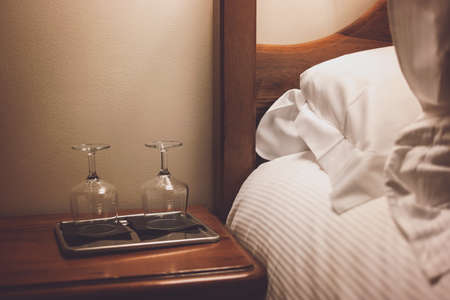Tray with wineglasses near bed. Two empty glasses. Hotel with best service.の写真素材