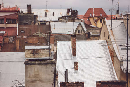 Antennas on rooftops. Town buildings and gloomy sky. Catch the signal.