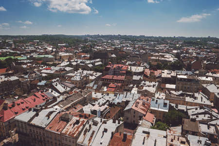 Town and blue cloudy sky. Buildings and trees. Old streets and historic landmarks.の写真素材