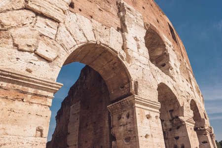 Ancient wall and arch. Old building on sky background. Look into history of architecture.の写真素材