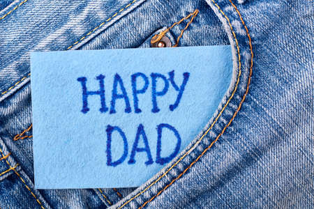 Dads card in jeans pocket. Greeting paper on denim. Congratulation for favourite daddy.の写真素材
