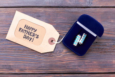 Cufflinks and Fathers Day tag. Label near box with cufflinks. Elegant present for daddy.の写真素材