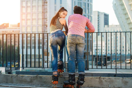 Back view of a couple. People on rollerblades standing. Ready for the ride.の写真素材