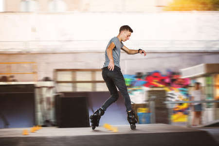 Young inline skater. Man on blurred background. Train and win.の写真素材