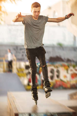 Person on inline skates. Rollerblader does a trick. Perfect balance and high speed.の写真素材