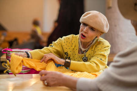 Surprised woman looking at clothes. Stylish elderly female. Renew the wardrobe.の写真素材