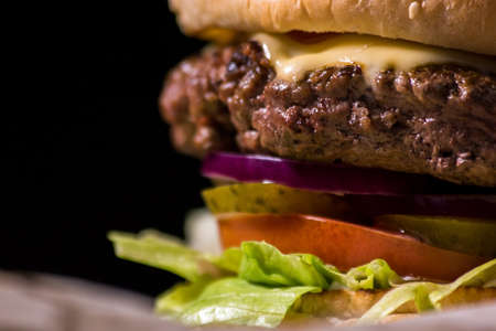 Close-up of a hamburger. Vegetable slices and grilled meat.の写真素材