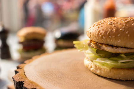 Hamburger on wooden board. Meat and slice of pickle.の写真素材
