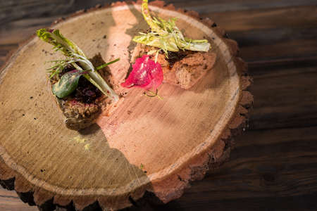 Two sandwiches on wood board. Bacon jam and lettuce.の写真素材