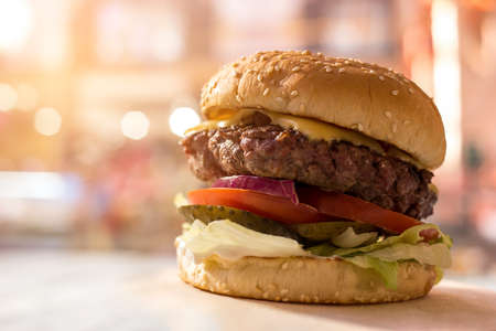 Burger with sesame seeds. Grilled cheese and meat. Fast food cafe commercial.の写真素材