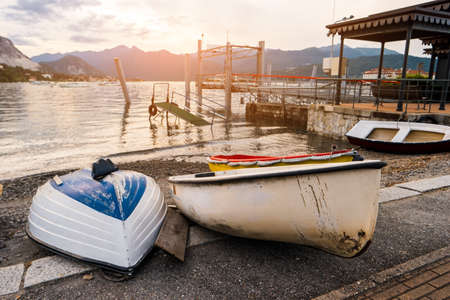 Boats on shore. Pier on background of mountains. Find quiet place for fishing.の写真素材