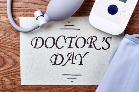 Electronic medical tonometer and card. Greeting for a doctor.の写真素材