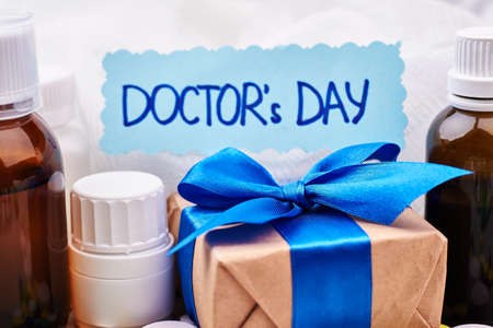 Bottles and containers with remedies. Greeting card and box. Cute Ñongratulation for Doctors Day.