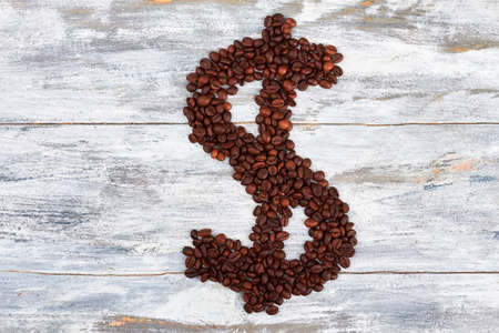 Dollar sign from coffee beans. Taste of wealth.