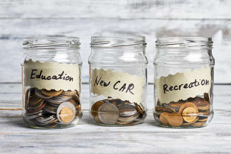 Three jars with coins. Donation for education and recreation.の写真素材