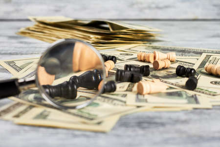 Chess, loupe and dollars. Profitable business strategy.の写真素材
