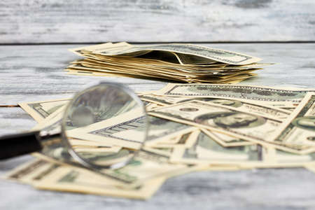 Magnifying glass and dollars. Increase your income.の写真素材